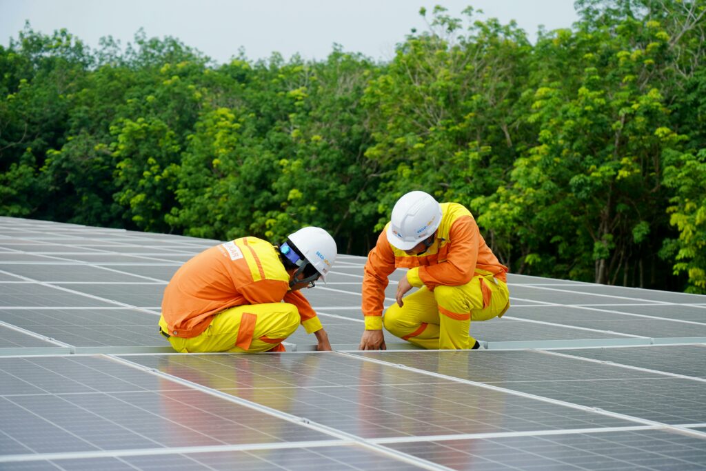 two men with hardhats installing residential solar panels